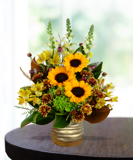 Maple Mood flower arrangement with sunflowers, yellow roses, bronze mums, and greenery in a copper vase.