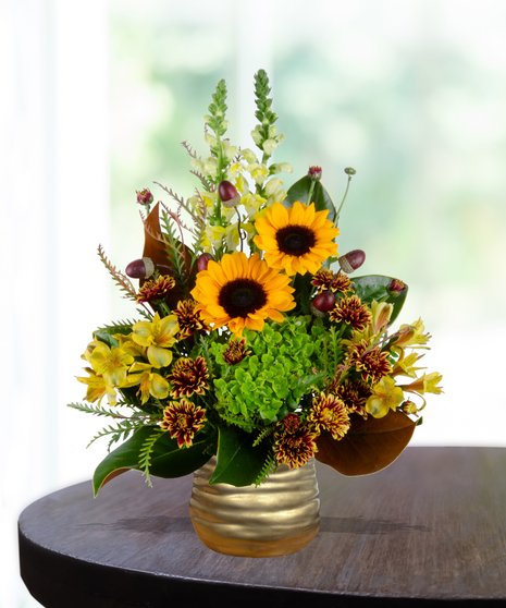 Maple Mood flower arrangement with sunflowers, yellow roses, bronze mums, and greenery in a copper vase.