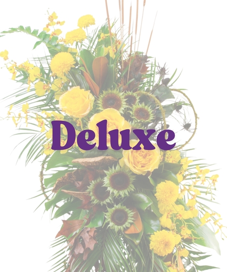 Meadow of Memories traditional funeral standing spray featuring yellow roses, cascading yellow orchids, naked sunflowers, and cattails on a wire easel.