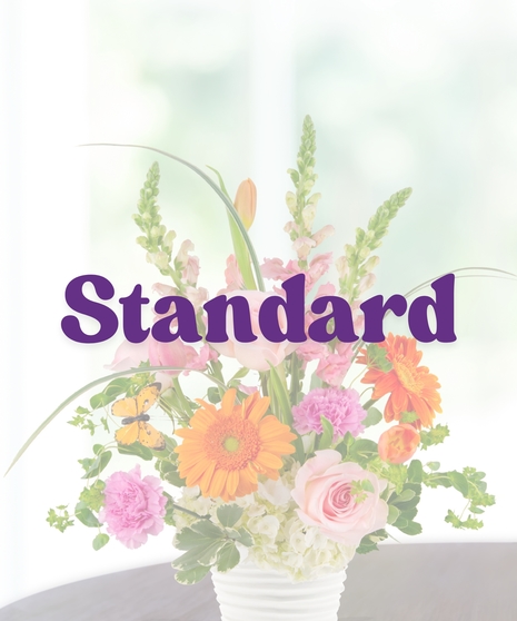 Pink Lemonade summer flower arrangement by Billy Heroman’s, featuring a mix of pink and orange flowers.