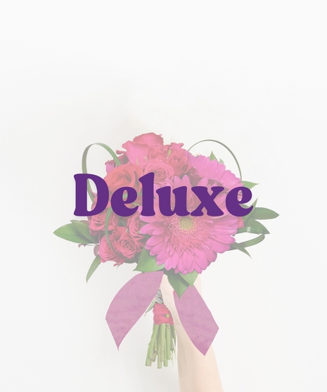 Pop Princess handheld bouquet with hot pink gerbera daisies, spray roses, and ribbon accent