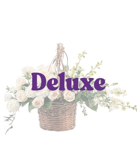 Purity Basket white sympathy flower arrangement featuring white roses, white carnations, white snapdragons, and lush green foliage in an 8-inch dark woven basket with a handle