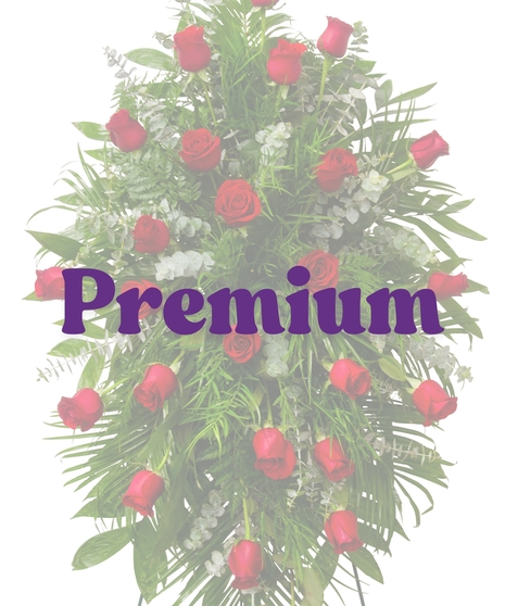 Red rose funeral standing spray with lush greenery from Billy Heroman’s Reverent Roses Suite in Baton Rouge