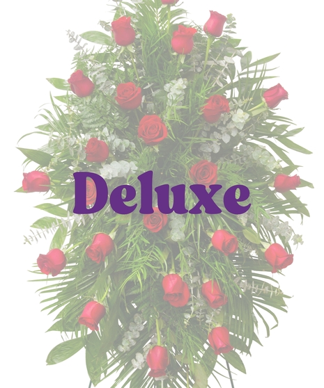 Red rose funeral standing spray with lush greenery from Billy Heroman’s Reverent Roses Suite in Baton Rouge