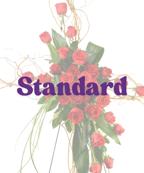 Cross-shaped funeral standing spray with red roses and curly willow branches from Billy Heroman’s Florist in Baton Rouge, LA