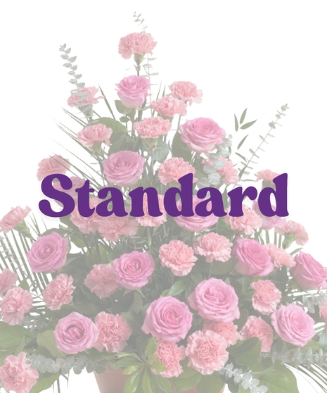 Roses & Carnations Floor Piece with pink roses, pink carnations, eucalyptus, and palm leaves in a triangular funeral display