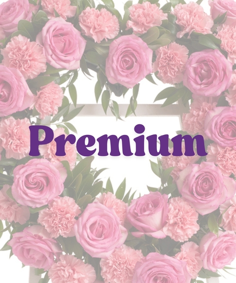 Roses & Carnations Heart Stand with pink roses, pink carnations, and greenery in a heart shape on a white easel