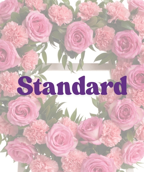 Roses & Carnations Heart Stand with pink roses, pink carnations, and greenery in a heart shape on a white easel