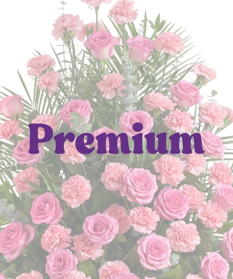 Roses & Carnations Urn Arrangement featuring pink roses, pink carnations, eucalyptus, and greenery in a pedestal vase
