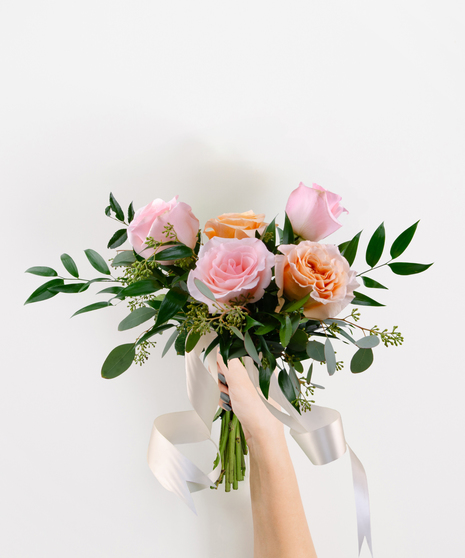 Runway Diva handheld bouquet with blush and pink roses, greenery, and ribbons for Homecoming or Prom