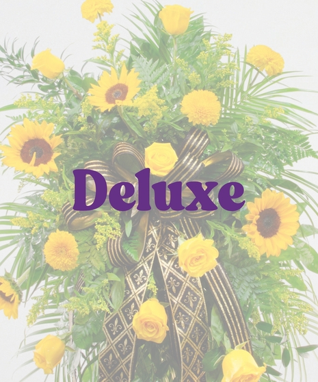 Saints traditional funeral standing spray featuring yellow sunflowers, yellow roses, yellow mums, and a black and gold fleur-de-lis ribbon on a wire easel.