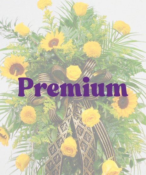 Saints traditional funeral standing spray featuring yellow sunflowers, yellow roses, yellow mums, and a black and gold fleur-de-lis ribbon on a wire easel.