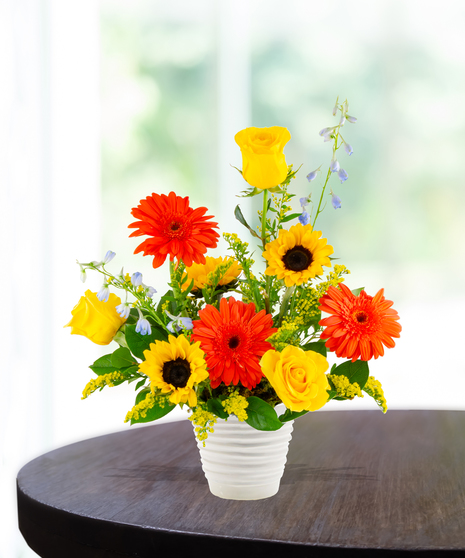 Sunny Side Up summer flower arrangement by Billy Heroman’s, featuring a mix of orange and yellow flowers.