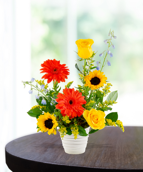 Sunny Side Up summer flower arrangement by Billy Heroman’s, featuring a mix of orange and yellow flowers.