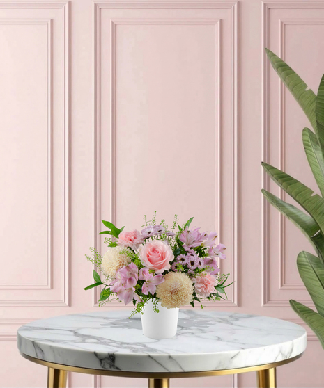 Sweetest Mum Mother's Day flower arrangement featuring light pink roses, ivory cremones, lavender daisies, and pink carnations in a matte white ceramic vase.