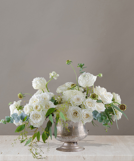 Sydney signature flower arrangement by Billy Heroman’s, featuring all white roses, spray roses, ranunculus, and more.