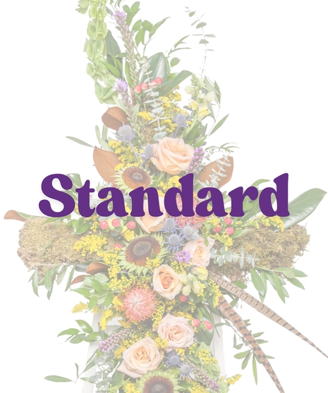 The Great Outdoors Cross Stand with peach roses, pincushion protea, moss, berries, and feathers on a white easel