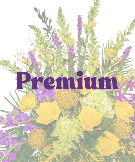 Tiger Pride Floor Funeral Arrangement with yellow roses, purple orchids, green hydrangeas, and tropical foliage