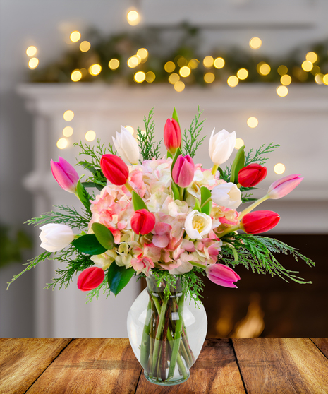A stunning arrangement of dark purple, red, and pink tulips in a vase.