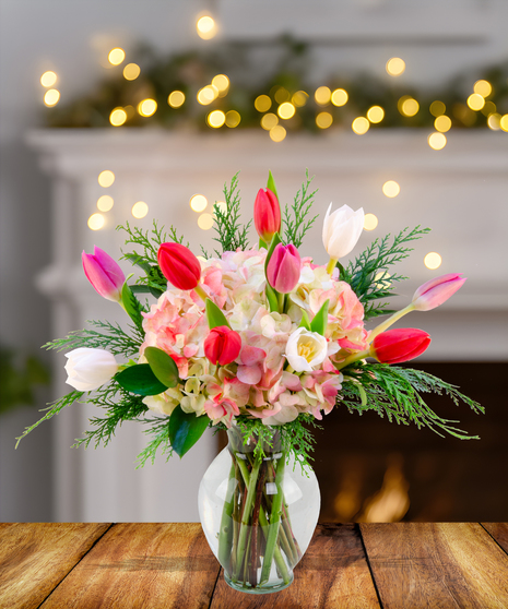 A stunning arrangement of dark purple, red, and pink tulips in a vase.