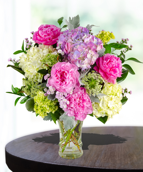 Unconditional Love Flower Arrangement: A heartwarming mix of peonies and hydrangeas in a traditional glassvase