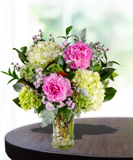 Unconditional Love Flower Arrangement: A heartwarming mix of peonies and hydrangeas in a traditional glassvase