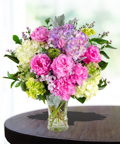 Unconditional Love Flower Arrangement: A heartwarming mix of peonies and hydrangeas in a traditional glassvase