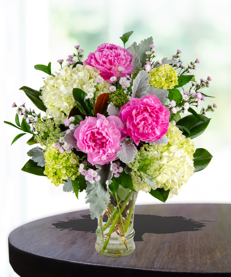 Unconditional Love Flower Arrangement: A heartwarming mix of peonies and hydrangeas in a traditional glassvase