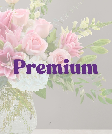 Unforgettable flower arrangement with pink roses, stargazer lilies, white hydrangeas, and eucalyptus in a tall clear vase