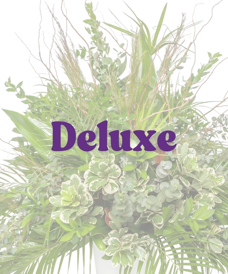 Lush green urn arrangement with Louisiana-inspired foliage and branches from Billy Heroman’s in Baton Rouge