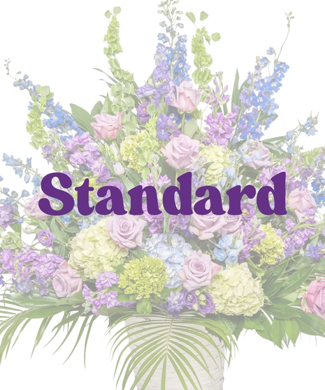 Bold Spring Mix urn arrangement with lavender roses, hydrangeas, lisianthus, and delphinium for funeral casket from Billy Heroman’s Florist in Baton Rouge, LA
