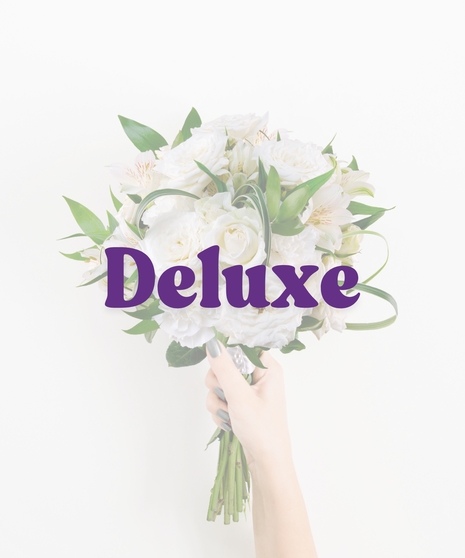 Glow Up handheld bouquet with white roses, alstroemeria, bear grass, and pearl pin wrap