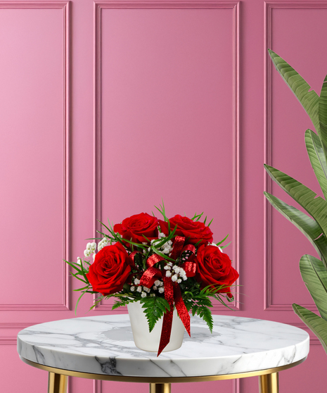 With All My Heart exclusive Valentine's flower arrangement with red roses, white baby's breath, and a red glitter ribbon in a white ceramic vase.