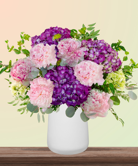 World Class Mom flower arrangement with pink peonies, lavender and green hydrangeas in a modern white vase – part of Billy Heroman’s Signature Mother’s Day Collection.