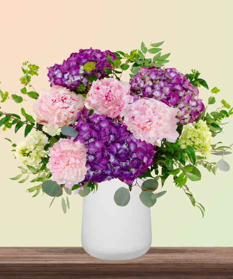 World Class Mom flower arrangement with pink peonies, lavender and green hydrangeas in a modern white vase – part of Billy Heroman’s Signature Mother’s Day Collection.