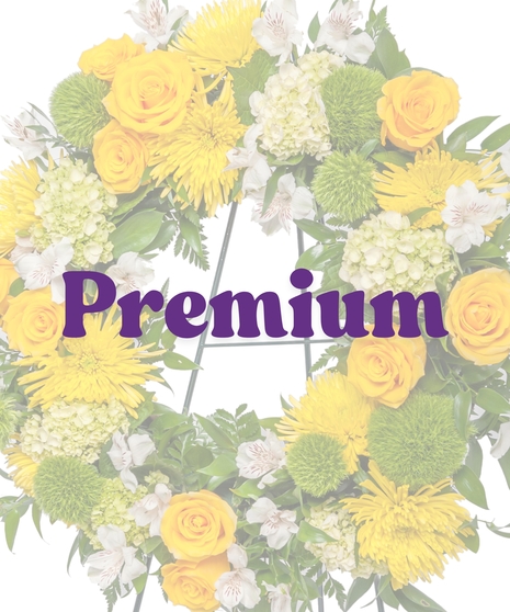 Yellow and white funeral wreath with roses, mums, and alstroemeria on an easel from Billy Heroman’s in Baton Rouge