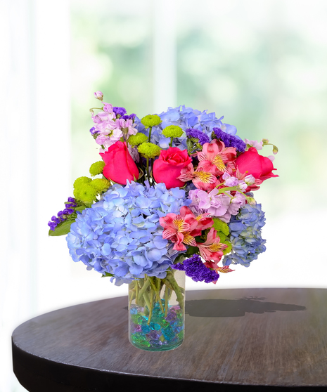 Colorful flowers in a gem-filled vase delivered in Baton Rouge.