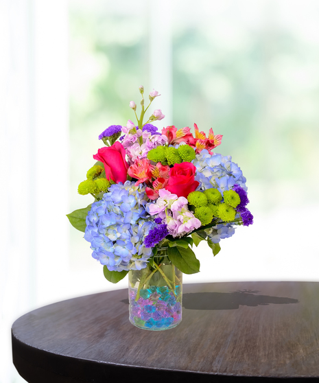 Colorful flowers in a gem-filled vase delivered in Baton Rouge.