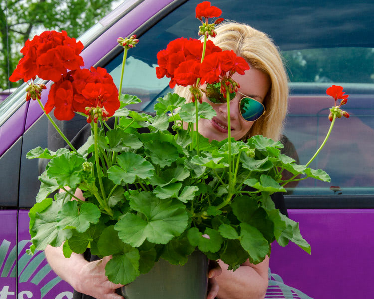 One of our floral designers smiles with her latest creation
